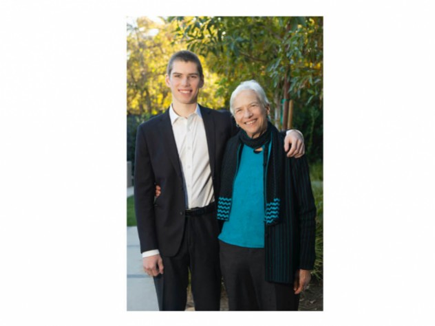 A grandson with his arm around his grandmother