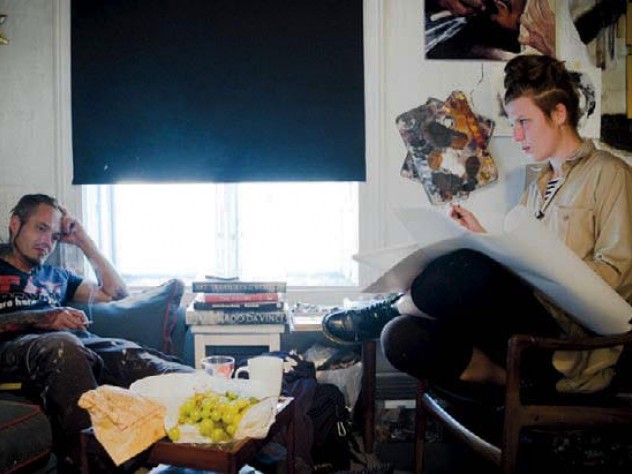 Artist drawing her subject in a room In a still from "The Painter and the Thief," the male thief watches the female artist at work.