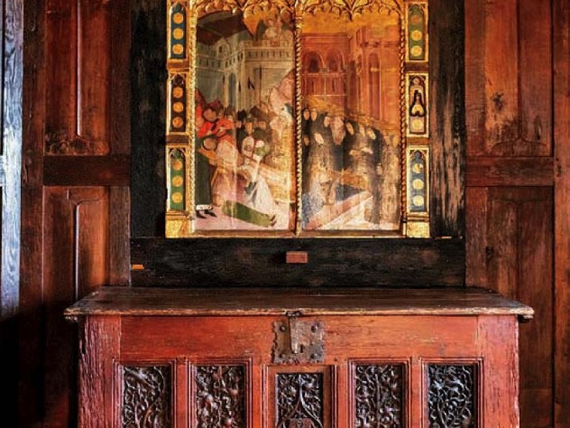 Dining room with antique chest and fifteenth-century religious painting or a martyrdom