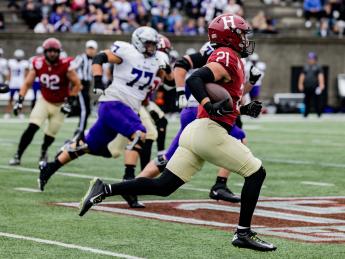 Harvard sophomore safety Ty Bartrum runs an intercepted St. Thomas pass back 96 yards for a touchdown.