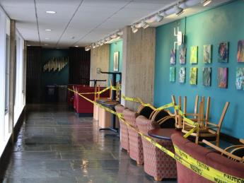 A hallway in Quincy House, with chairs cordoned off limits against the wall