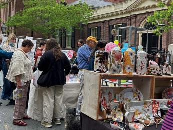 People outside at art vendors' stalls at the RISD Craft fair  