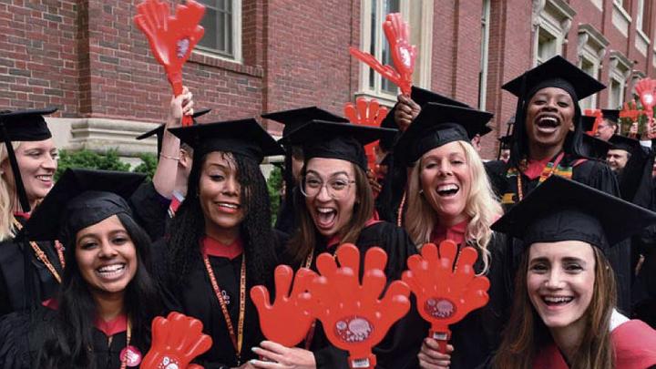 Harvard students in caps and gowns enjoying Commencement 