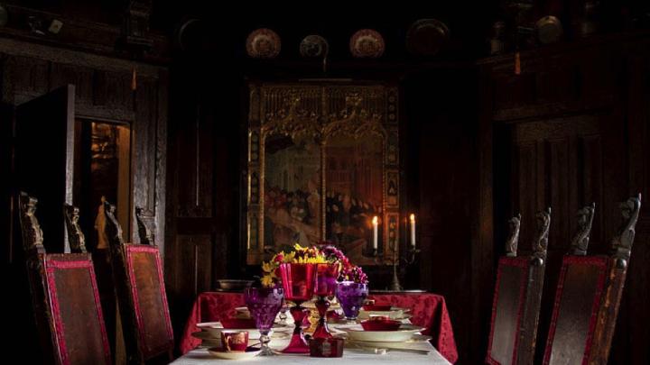 A Gothic-style dining room, with the table set for a formal dinner