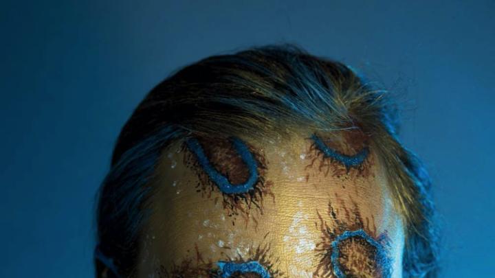 Shelby Meyerhoff's photographic self-portrait of her head and shoulders transformed with body paints into a blue-ringed octopus
