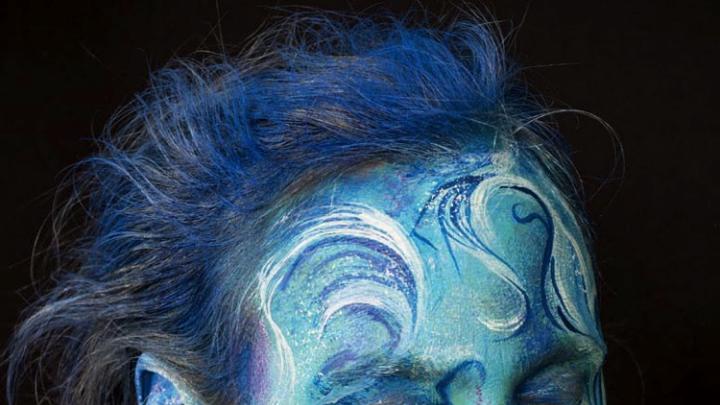 Meyerhoff's self-portrait as “ocean waves”—with blue hair, blue skin, and blue and white swirls indicating waves